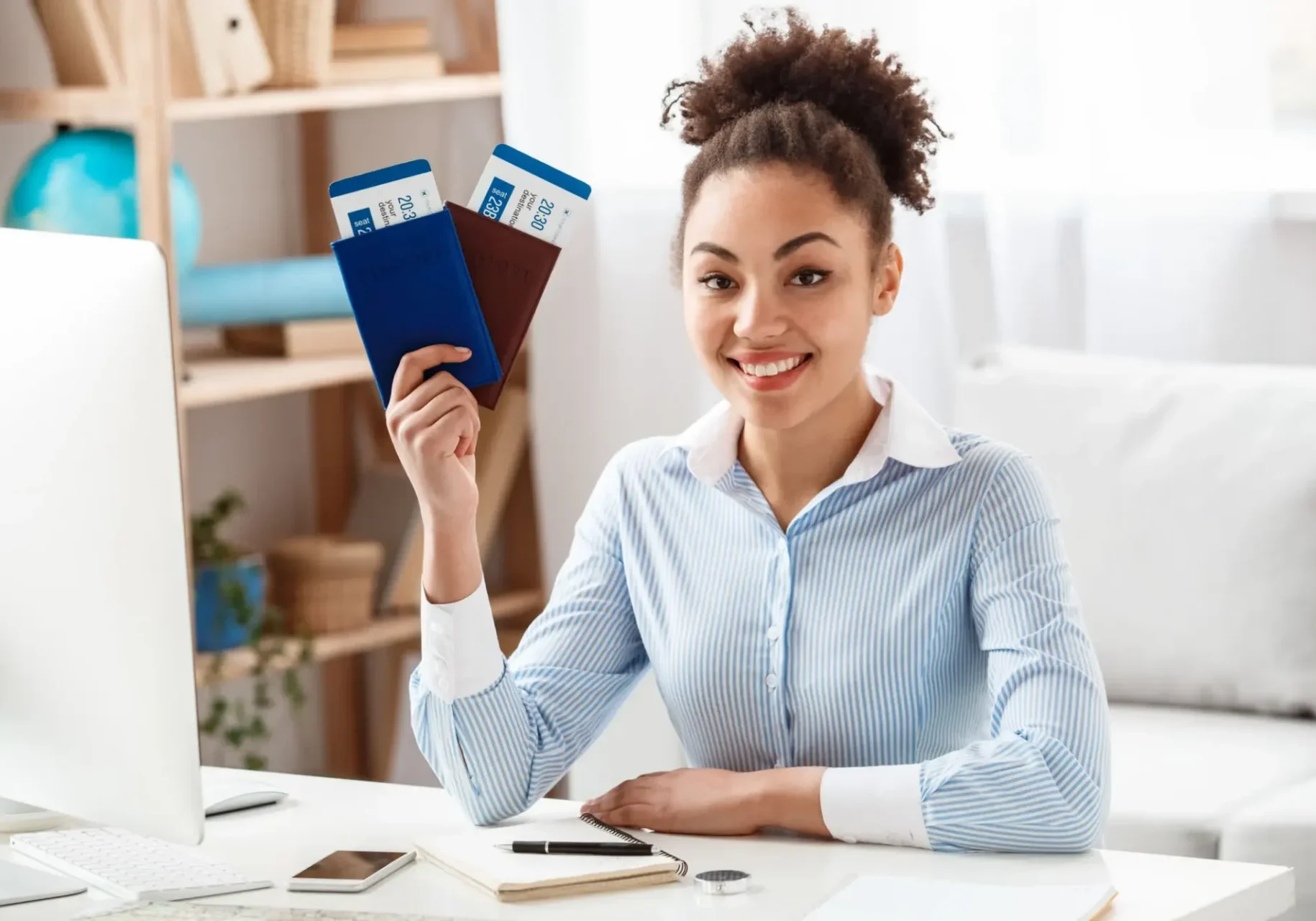 Smiling woman holding passports and boarding passes