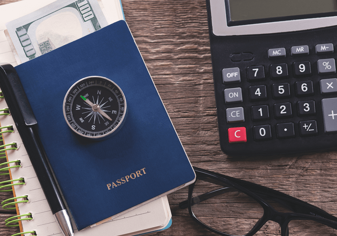 Passport with compass and calculator, travel planning