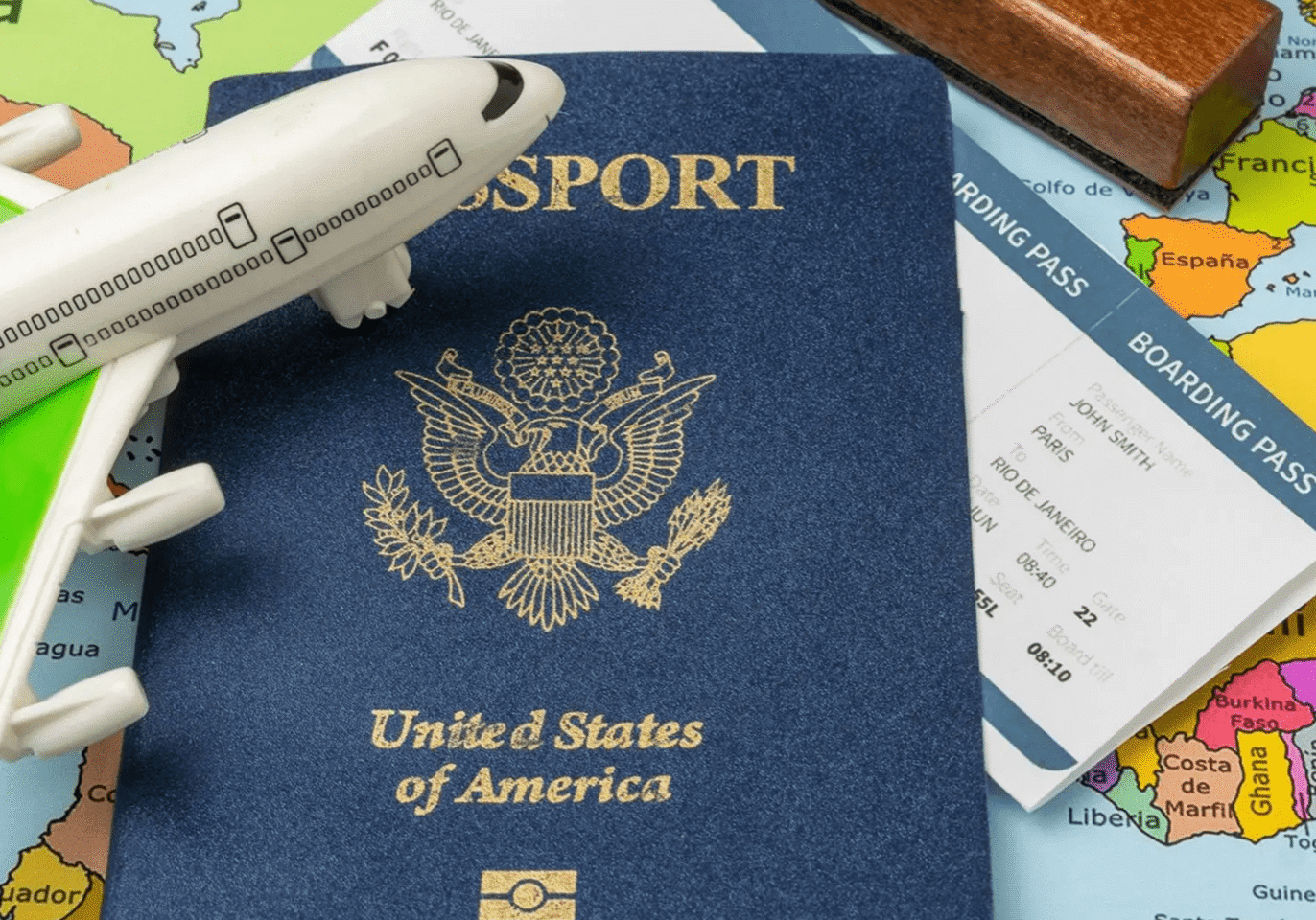 US passport, boarding pass, toy airplane
